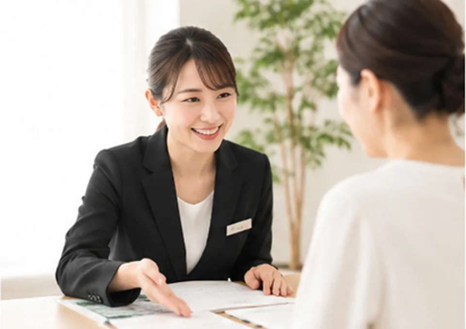 書類を見せながら説明する女性スタッフ
